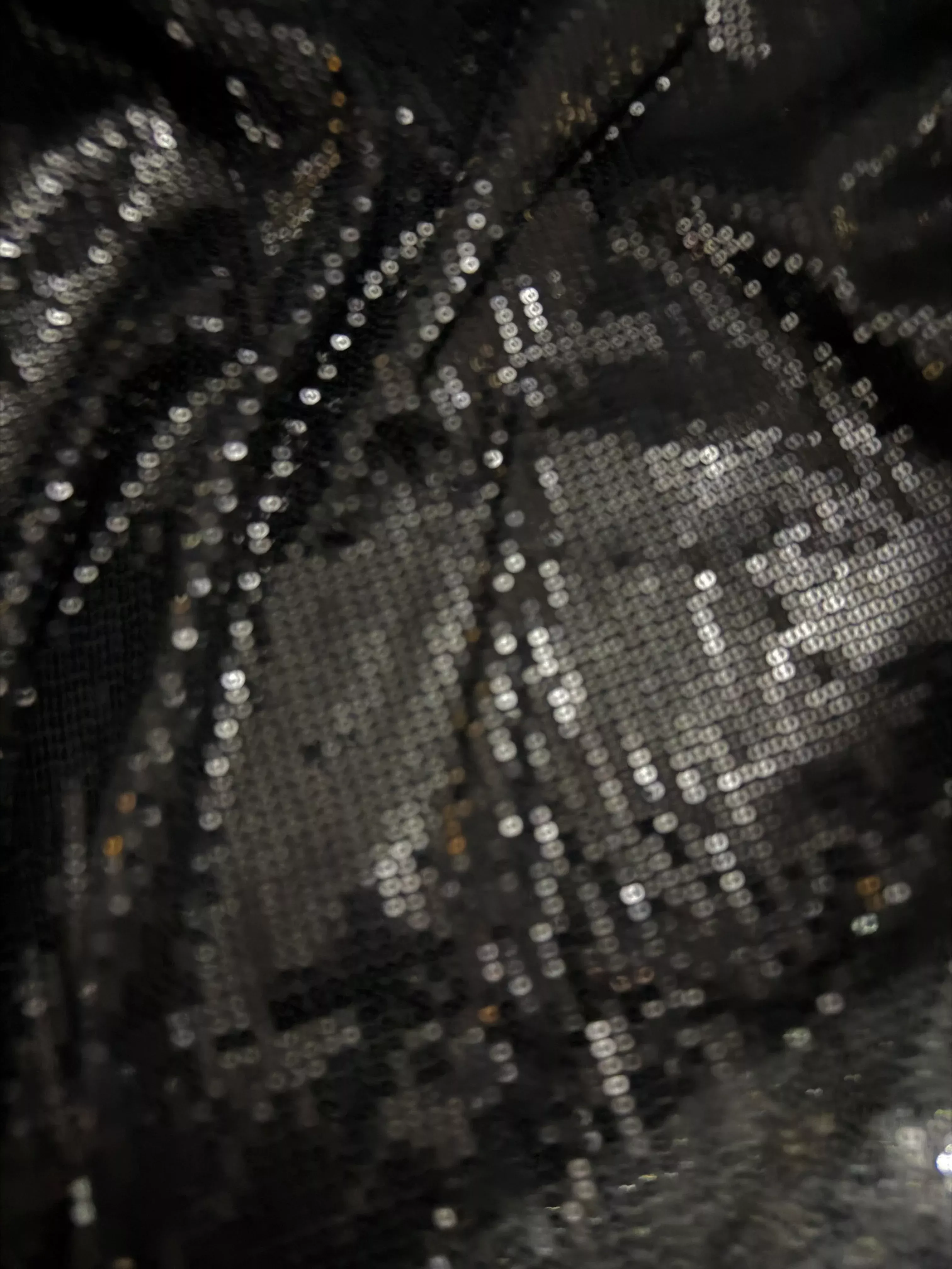 Black Allover sequin fabric on fine stretch knit.